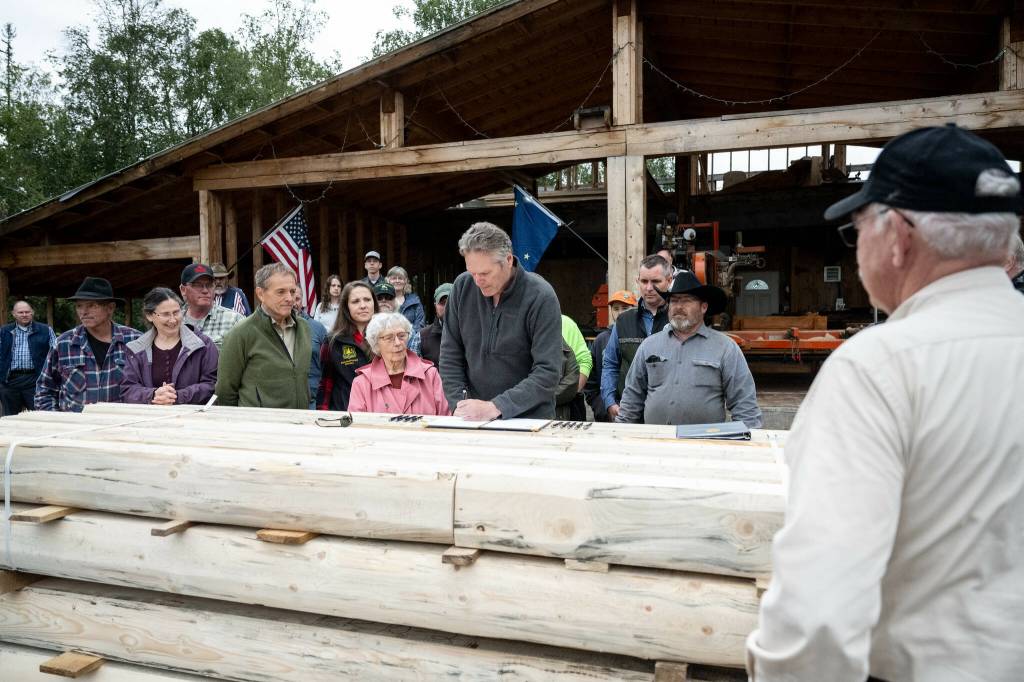 Photo courtesy Gov. Mike Dunleavys Office
Gov. Mike Dunleavy signs S.B. 7 into law at Papoose Milling on Wednesday in Big Lake.