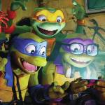 April O'Neil, Leonardo, Michelangelo, Donatello and Raphael gather around a cell phone in "Teenage Mutant Ninja Turtles: Mutant Mayhem." (Photo courtesy Paramount)