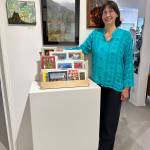 Lorna Branzuela stands with some of her artwork at Fireweed Gallery on Saturday, Sept. 2, 2023 in Homer, Alaska. Branzuela's exhibit will be on display through September. Photo by Christina Whiting