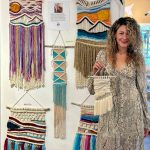 Artist Chelsea Carpenter poses with her macraweave art, now available year-round at Ptarmigan Arts, on Thursday, Sept. 7, 2023 in Homer, Alaska. Photo by Christina Whiting