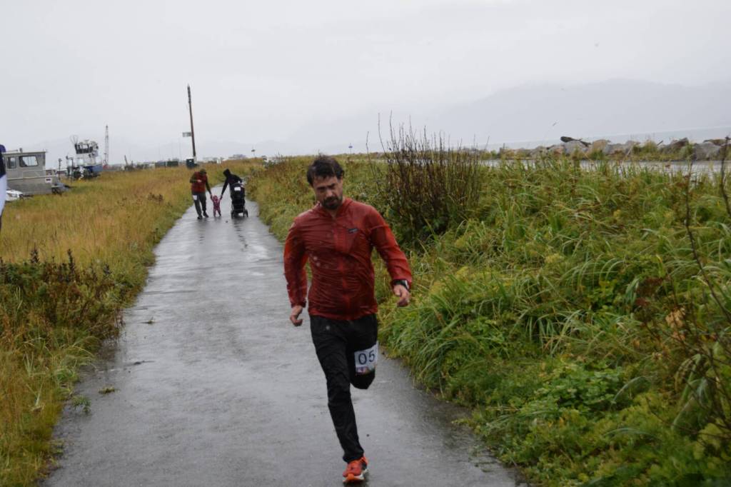 Runner Martin Shuster crosses the finish line first in the 5K Run for Recovery on Saturday, Sept. 16, 2023 on the Spit in Homer, Alaska. Shuster was awarded a prize for "First Place Adult Man" in the ceremony following the race. (Delcenia Cosman/Homer News)
