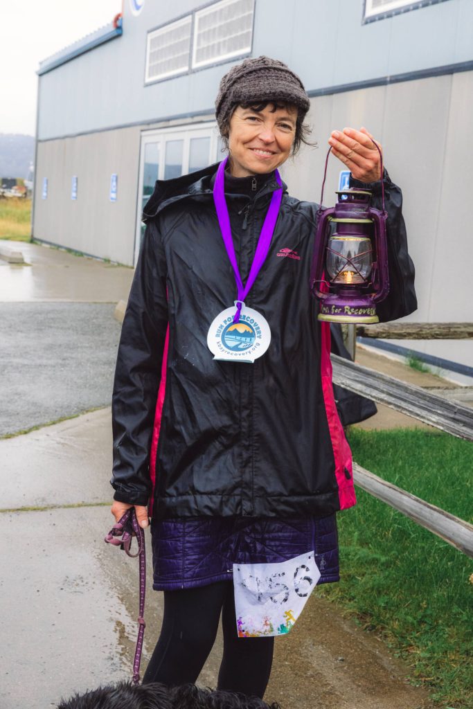 SVT Health and Wellness Coach Jenifer Dickson is awarded the traditional red lantern, painted purple to celebrate recovery, for being the last one to finish at the 5K Run for Recovery on Saturday, Sept. 16, 2023 on the Spit in Homer, Alaska. Photo by Arctic Stills Photography