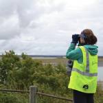 Peninsula Clarion file
Alaska Wildlife Alliance member Grace Kautek looks out over the Kenai River for signs of belugas during the third annual Belugas Count! event at Erik Hansen Scout Park in Kenai on Sept. 21, 2019.