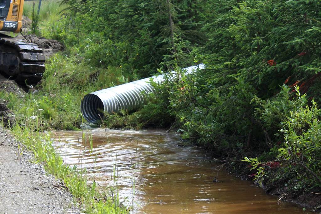 Water pools near at the intersection of Patrick Drive and Bjerke Street, where contractors for the Kenai Peninsula Borough install a culvert to mitigate flooding off of Kalifornsky Beach Road on Friday, July 21, 2023, near Kenai, Alaska. (Ashlyn OHara/Peninsula Clarion)