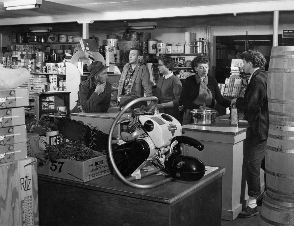 1954 photo by Bob and Ira Spring for Better Homes & Garden magazine
Rusty Lancashire (far right) chats with Helen Jones inside a busy Kenai Commercial Company store.