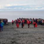 Alaska SeaLife Center staff part the crowd before releasing three harbor seals at North Kenai Beach in Kenai, Alaska, on Saturday, Sept. 23, 2023. (Jake Dye/Peninsula Clarion)