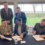 Clockwise from bottom left: U.S. Army Corps of Engineers Alaska Division Commander Col. Jeff Palazzini, Gov. Mike Dunleavy, Kenai Mayor Brian Gabriel, Kenai City Manager Terry Eubank and Assistant Secretary of the Army for Civil Works Michael Connor participate in a signing ceremony for a project partnership agreement for the Kenai Bluff Stabilization Project at the Kenai Senior Center on Monday, Sept. 25, 2023, in Kenai, Alaska. (Jeff Helminiak/Peninsula Clarion)