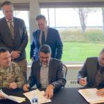 Clockwise from bottom left: U.S. Army Corps of Engineers Alaska Division Commander Col. Jeff Palazzini, Gov. Mike Dunleavy, Kenai Mayor Brian Gabriel, Kenai City Manager Terry Eubank and Assistant Secretary of the Army for Civil Works Michael Connor participate in a signing ceremony for a project partnership agreement for the Kenai Bluff Stabilization Project at the Kenai Senior Center on Monday, Sept. 25, 2023, in Kenai, Alaska. (Jeff Helminiak/Peninsula Clarion)