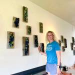 Artist Krista Etzwiler hangs her ceramic pinch pots on reclaimed wood at The Bagel Shop on East End Road in August in Homer, Alaska. Photo provided by Krista Etzwiler