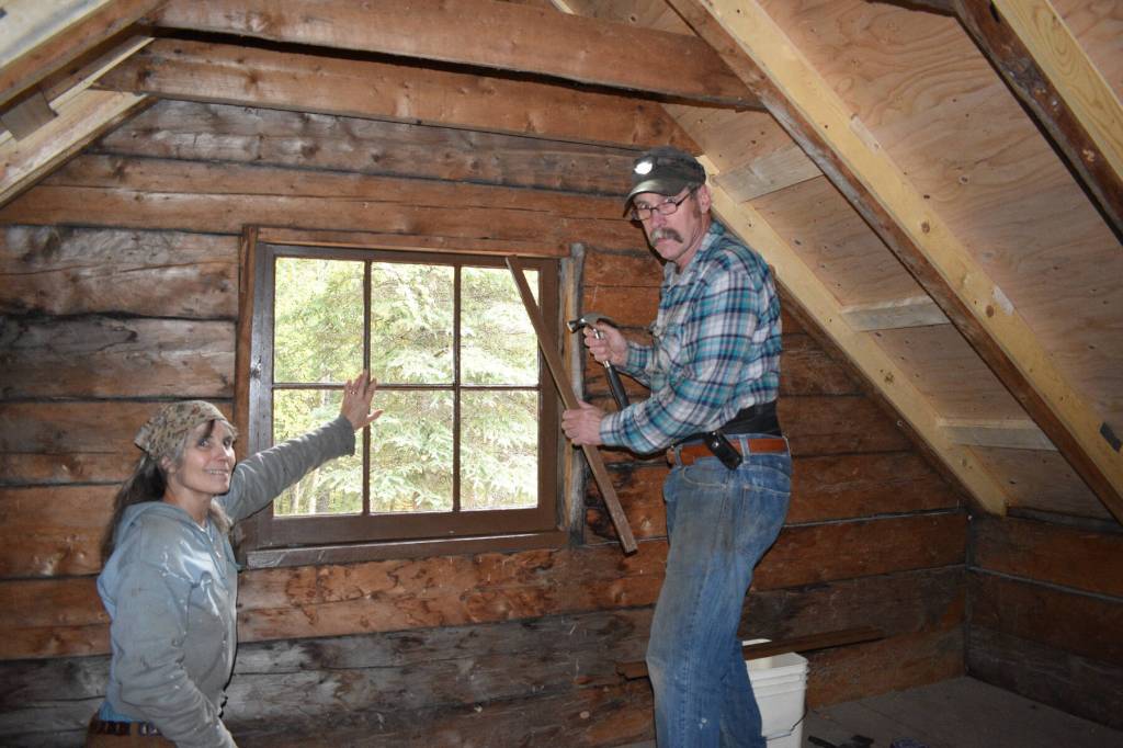 Anne Coray (left) and her husband, Steve Kahn (right) work in the loft of Brown Carlsons cabin on Lake Clark during their rebuilding project in September 2018. Photo provided by Anne Coray and Steve Kahn