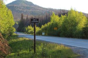 A sign indicates the turn for Jims Landing on Skilak Lake Road on Sunday, June 13, 2021, near Skilak Lake on the Kenai Peninsula in Alaska. (Ashlyn OHara/Peninsula Clarion)