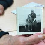 Ashlyn OHara/Peninsula Clarion
Mary Lou Bottorff, a survivor of Holy Cross Mission, holds a picture taken of her en route to the mission taken in Nome in 1948, when she was 8 years old, inside the Tyotkas Elder Center on Oct. 4 in Kenai.