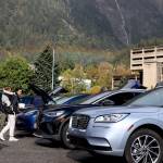 A rainbow appears over downtown as residents check out rows of electric vehicles at Juneaus EV & E-bike Roundup on Sept. 23. (Clarise Larson / Juneau Empire File)
