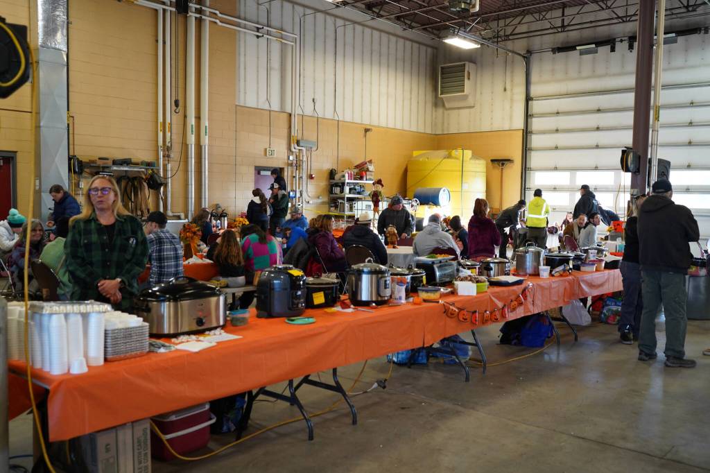 A series of pots full of chili fill tables during Kenai Aviations Fifth Annual Pumpkin Drop at the Kenai Municipal Airport Operations Building in Kenai, Alaska, on Saturday, Oct. 21, 2023. (Jake Dye/Peninsula Clarion)