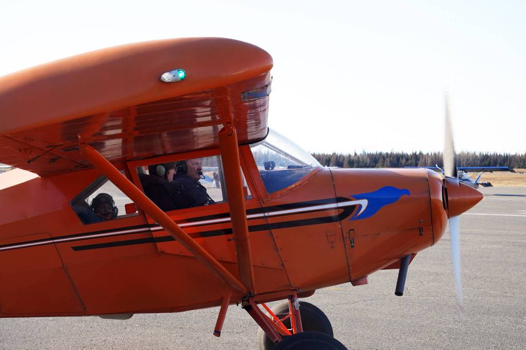 Joel Caldwell, right, returns from a flight in his personal aircraft during Kenai Aviations Fifth Annual Pumpkin Drop at the Kenai Municipal Airport Operations Building on Saturday, Oct. 21, 2023. (Jake Dye/Peninsula Clarion)