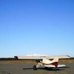 A plane idles on the runway, waiting to depart with a pumpkin, during Kenai Aviations Fifth Annual Pumpkin Drop at the Kenai Municipal Airport Operations Building in Kenai, Alaska, on Saturday, Oct. 21, 2023. (Jake Dye/Peninsula Clarion)