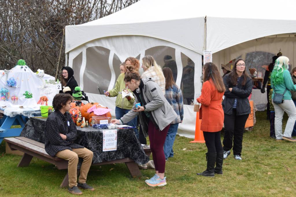 Community members vote for their favorite carved pumpkin at the Fall Fest at the Homer Chamber of Commerce on Saturday, Oct. 28, 2023 in Homer, Alaska. (Delcenia Cosman/Homer News)