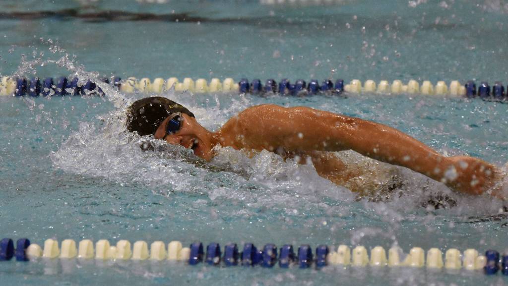 Sewards Bengimin Ambrosiani helps his team to victory in the 400-yard freestyle relay Saturday, Oct. 28, 2023, at the Northern Lights Conference swim meet at Soldotna High School in Soldotna, Alaska. (Photo by Jeff Helminiak/Peninsula Clarion)