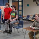 Alex Collet and Boyd Lehmberg watch as Kenais Kenneth White and Nikiskis Levi Kimbell compete in Super Smash Bros. Ultimate at Nikiski Middle/High School in Nikiski, Alaska, on Monday, Oct. 23, 2023. (Jake Dye/Peninsula Clarion)