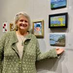 Artist Cindy Nelson poses with her three oil paintings on display in Homer Council on the Arts current Fun with 5x7 exhibit on Thursday, Nov. 9, 2023 in Homer, Alaska. Photo provided by Cindy Nelson