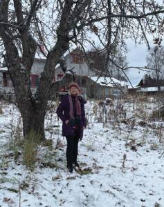 Homer musician Sunrise Sjoberg stands in front of the home she was born in near Thurston Drive on East End Road in Homer . Sunrise is the November featured musician at Bunnells Arts by Air program. (Emilie Springer/Homer News)