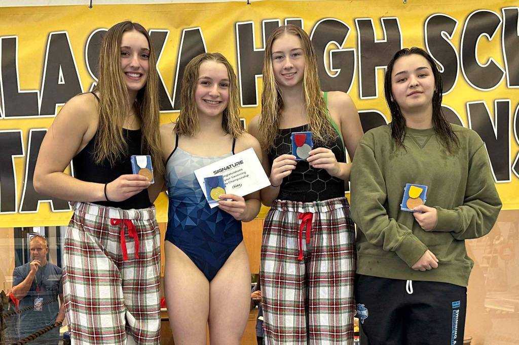 Colony's Claire Wallstrum, Soldotna's Abriella Werner, Colony's Charlie McManus and Service's Faith Colman on the diving podium at the state swimming and diving meet in Juneau, Alaska, on Saturday, Nov. 4, 2023. Werner won the state title. (Photo provided)