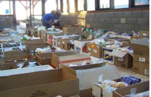 Volunteers help organize more than 200 boxes of food Saturday morning, part of the Lions Club Thanksgiving Basket program. Homer News file photo.