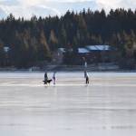 Skaters play on the frozen Beluga Lake, enjoying the sunshine on Monday, Nov. 20, 2023 in Homer, Alaska. (Delcenia Cosman/Homer News)