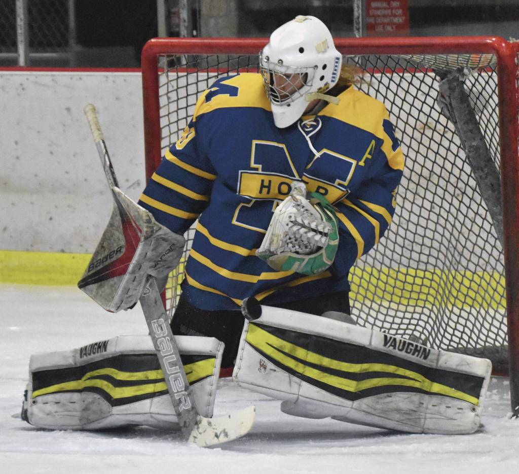 Photo by Jeff Helminiak/Peninsula Clarion
Homers Blaise Banks makes a save against Kenai Central on Thursday, Nov. 30, 2023, at the Kenai Multi-Purpose Facility in Kenai, Alaska.