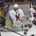 Kenai Central's Seanna Swanson and Sawyer Vann look to block a shot Thursday, Nov. 30, 2023, at the Kenai Multi-Purpose Facility in Kenai, Alaska. (Photo by Jeff Helminiak/Peninsula Clarion)