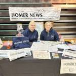 Callie Steinberg (left) and Cara Hall (right) operate a booth for the Homer News at the Procrastinators Fair at West Homer Elementary on Saturday, Dec. 9, 2023 in Homer, Alaska. Photo courtesy of Callie Steinberg