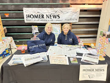 Callie Steinberg (left) and Cara Hall (right) operate a booth for the Homer News at the Procrastinators Fair at West Homer Elementary on Saturday, Dec. 9, 2023 in Homer, Alaska. Photo courtesy of Callie Steinberg