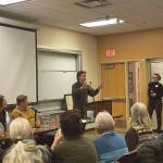 Homer city council member Jason Davis (center) speaks to the audience gathered in Pioneer Hall for the Israel-Palestine conflict panel discussion on Friday, Dec. 15<ins>, 2023</ins> at Kachemak Bay Campus<ins> in Homer, Alaska</ins>. Davis formerly served in the political section of the U.S. Embassy in Tel Aviv. (Emilie Springer/Homer News)