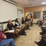 Kachemak Bay Campus programs coordinator Jill Burnham (far right) welcomes the audience to the Israel-Palestine conflict panel discussion on Friday, Dec. 15<ins>, 2023</ins> at Kachemak Bay Campus<ins> in Homer, Alaska</ins>. (Emilie Springer/Homer News)
