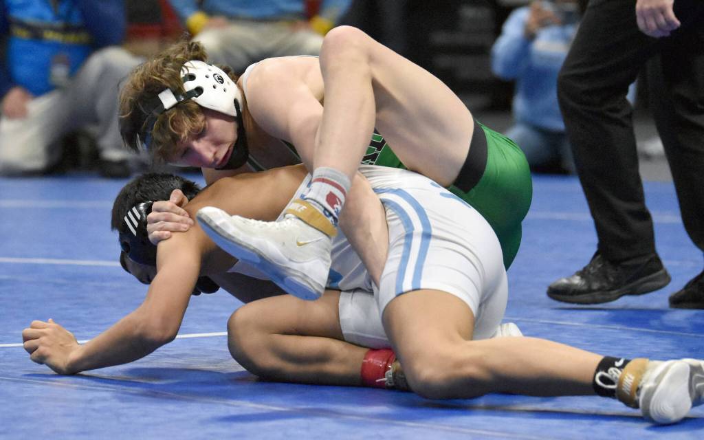 Sewards Hunter Forshee-Kurtz works his way to a pin of Tristan Tilden in the Division II title match at 130 pounds Saturday, Dec. 16, 2023, at the state wrestling tournament at the Alaska Airlines Center in Anchorage, Alaska. (Photo by Jeff Helminiak/Peninsula Clarion)