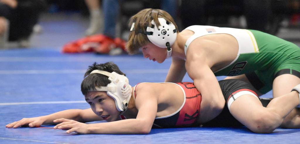 Sewards Tommy Jarnig works his way to a technical fall over Chevaks Laiton Pingayak in the Division II final at 103 pounds Saturday, Dec. 16, 2023, at the state wrestling tournament at the Alaska Airlines Center in Anchorage, Alaska. (Photo by Jeff Helminiak/Peninsula Clarion)