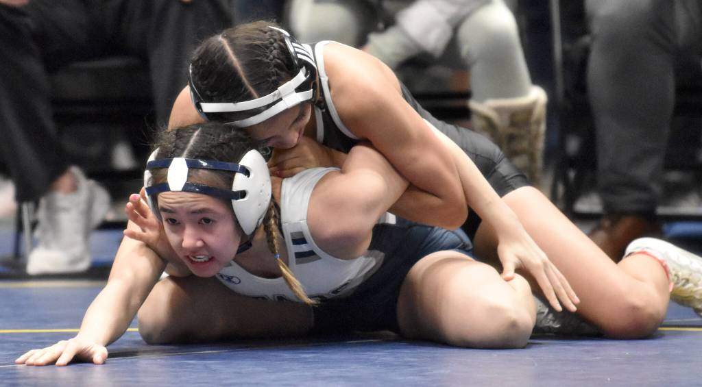 Soldotnas Jessica LeClair works her way to a pin of Wasillas Kaelynn Seidl in the girls finals at 100 pounds Saturday, Dec. 16, 2023, at the state wrestling tournament at the Alaska Airlines Center in Anchorage, Alaska. (Photo by Jeff Helminiak/Peninsula Clarion)