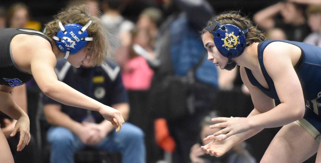 Homers Saoirse Cook works her way to a pin of Palmers Sarah Callender in the girls title match at 126 pounds Saturday, Dec. 16, 2023, at the state wrestling tournament at the Alaska Airlines Center in Anchorage, Alaska. (Photo by Jeff Helminiak/Peninsula Clarion)