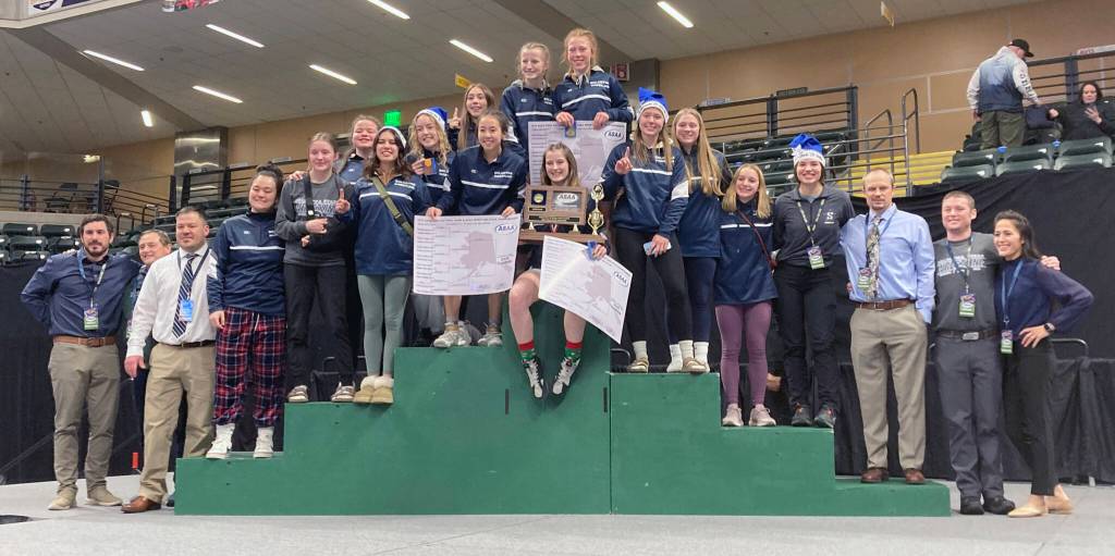 Soldotna celebrates winning the girls state wrestling title Saturday, Dec. 16, 2023, at the state wrestling tournament at the Alaska Airlines Center in Anchorage, Alaska. (Photo by Jeff Helminiak/Peninsula Clarion)