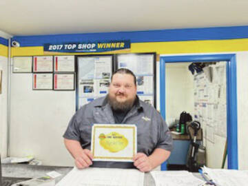 Callie Steinberg/Homer News
Jon Rudy, assistant manager at Alyeska Tire, poses with the Best of Business award for Best Tire Service on Friday, Dec. 15<ins>, 2023</ins> at the Alyeska Tire Shop<ins> in Homer, Alaska</ins>.