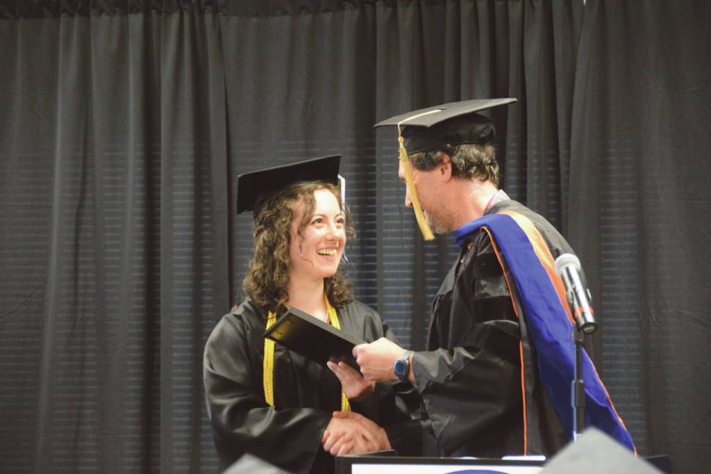 Kachemak Bay Campus Assistant Professor of Mathematics Dr. Jeff Johnson (right) presents the KBC Faculty Choice Award to valedictorian Elizabeth Rozeboom (left) during the 2023 KBC Commencement on Wednesday, May 10<ins>,</ins><ins> 2023 in Homer, </ins><ins>Alaska</ins>. Photo by Delcenia Cosman