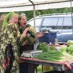 Jen Castellani from Will Grow Farm (right) is crowned the new Zucchini Queenie by the former queen, Luba Dorvall from Lubas Garden (left) at the Homer Farmers Market Zucchini Festival on Saturday, Aug. 26<ins>,</ins><ins> 2023 in Homer, </ins><ins>Alaska</ins>. (Delcenia Cosman/Homer News)
