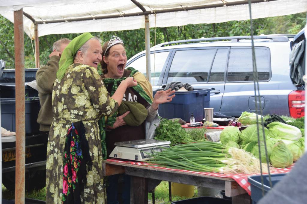 Jen Castellani from Will Grow Farm (right) is crowned the new Zucchini Queenie by the former queen, Luba Dorvall from Lubas Garden (left) at the Homer Farmers Market Zucchini Festival on Saturday, Aug. 26<ins>,</ins><ins> 2023 in Homer, </ins><ins>Alaska</ins>. (Delcenia Cosman/Homer News)