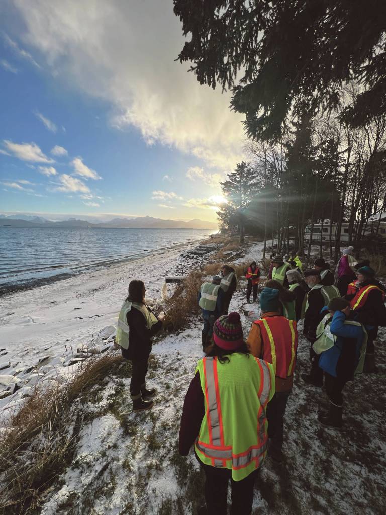 Walk on the Wild Side participants observe an outfall into Kachemak Bay on Friday, Dec. 8<ins>,</ins><ins> 2023</ins> near Colin Tolmans shop, Tolman Skiffs<ins> in Homer, </ins><ins>Alaska</ins>. The water coming from this outfall has been filtered by pristine peatlands and is cleaner than other nearby outfalls. Walk on the Wild Side is a hands-on community field walk at the site of a new City of Homer Green Infrastructure Project near Kachemak Drive. Participants learn how this project will mitigate flooding and erosion, improve water quality, and support the Lower Kenai Peninsula moose population.
