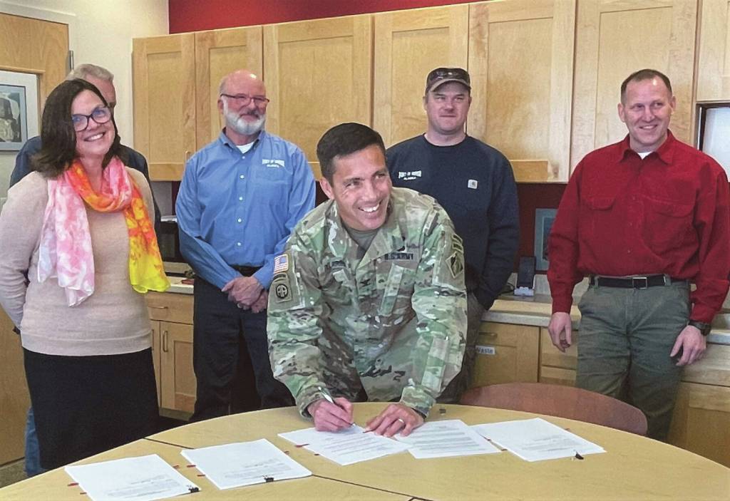 Col. Damon Delarosa, Alaska District Commander USACE (front) signs the feasibility cost-share agreement with the City of Homer on Wednesday, March 29<ins>,</ins><ins> 2023</ins> at the Harbormasters Office<ins> in Homer, </ins><ins>Alaska</ins>. Pictured in the back from left to right are Melissa Jacobsen, City Clerk & Acting City Manager; Bryan Hawkins, Harbormaster & Port Director; Aaron Glidden, Port Maintenance Supervisor; and Bruce Sexauer, Chief, Civil Works Project Management at USACE.