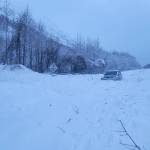 A vehicle is surrounded by avalanche debris along the Seward Highway on Sunday, Dec. 24, 2023 near Cooper Landing, Alaska. (Photo courtesy Alaska Department of Transportation and Public Facilities)