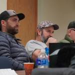 Scott Daletas, Monte Roberts and Jerry Strieby, all of whom sit in sport fishing guide seats, discuss proposals during a meeting of the Kenai/Soldotna Fish and Game Advisory Committee at Cook Inlet Aquaculture Association in Kenai, Alaska, on Monday, Jan. 8, 2024. (Jake Dye/Peninsula Clarion)