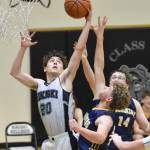 Nikiskis Dylan Hall battles for the rebound with Homers Nathan Overson and Einar Pederson on Friday, Jan. 12, 2024, at Nikiski Middle-High School in Nikiski, Alaska. (Photo by Jeff Helminiak/Peninsula Clarion)