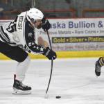 Soldotnas Gehret Medcoff takes a shot in front of Homers Cody Thomas on Thursday, Jan. 18, 2024, at the Soldotna Regional Sports Complex in Soldotna, Alaska. (Photo by Jeff Helminiak/Peninsula Clarion)