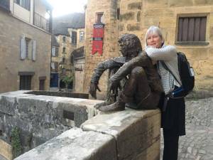Artist Deb Lowney poses with a statue in France in 2017. Photo provided by Deb Lowney